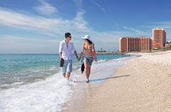 Beach with couple walking Beach with couple walking
