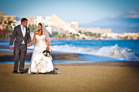 Bride & Groom walking on beach at Sunset Beach Club